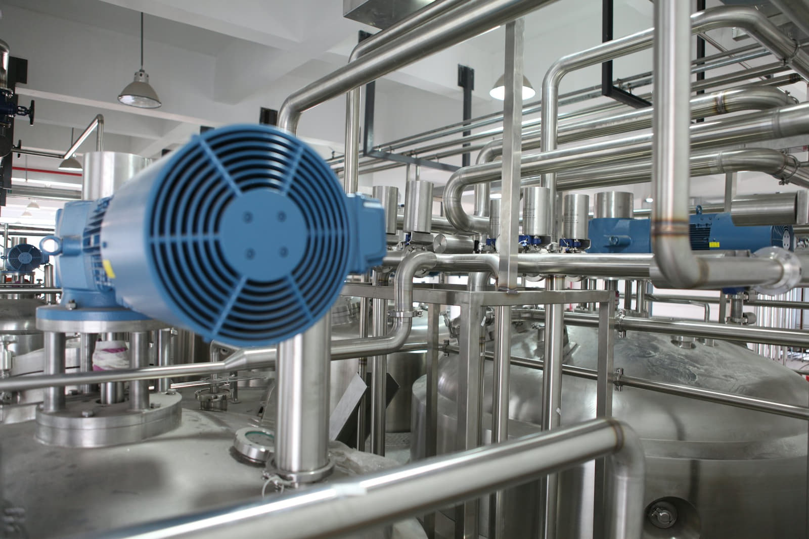 Stainless tanks and process pipework in a food-grade treatment hall